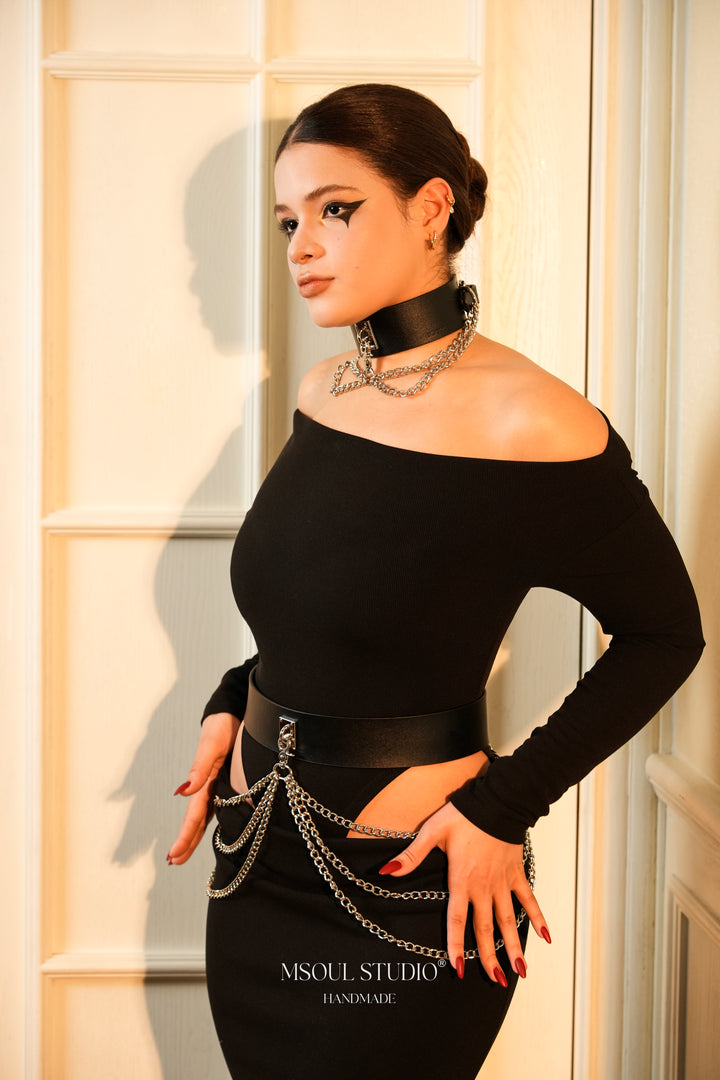 Model with a hand on the hip wearing the Cascade Chain Belt
