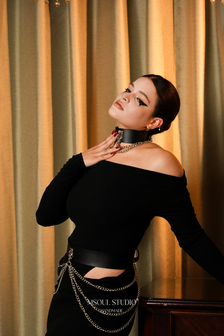 Model in black off-shoulder dress wearing the Cascade collar and chain belt