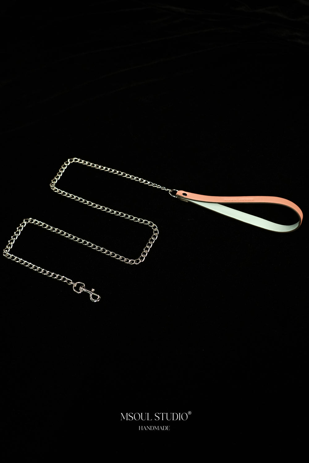 Pink and pale blue vegan leather handle with a looping silver-tone chain and clasp