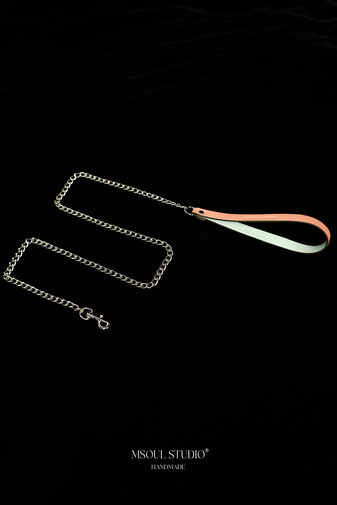 Pink and pale blue vegan leather handle with a looping silver-tone chain and clasp